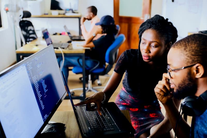 African software developers collaborating at their workstation